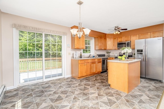 380 Leo Dr, Gardner, MA 01440 - kitchen featuring stainless steel appliances, light countertops, plenty of natural light, and a baseboard heating unit