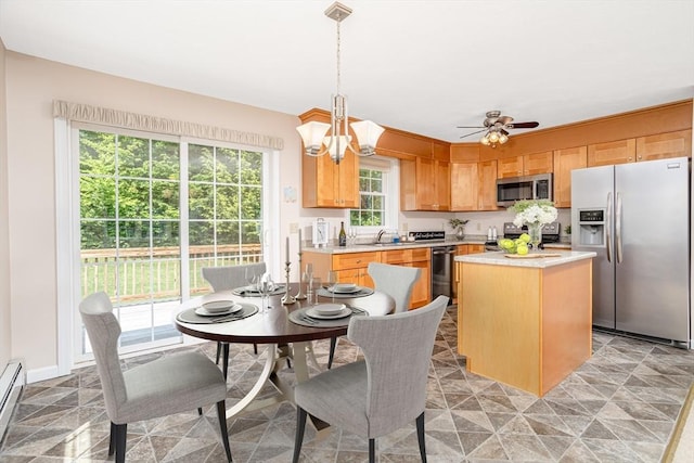 380 Leo Dr, Gardner, MA 01440 - kitchen featuring appliances with stainless steel finishes, light countertops, a center island, baseboard heating, and a chandelier