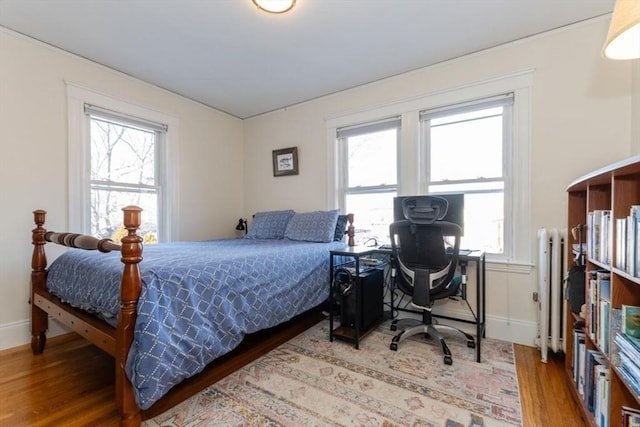 bedroom featuring baseboards and wood finished floors