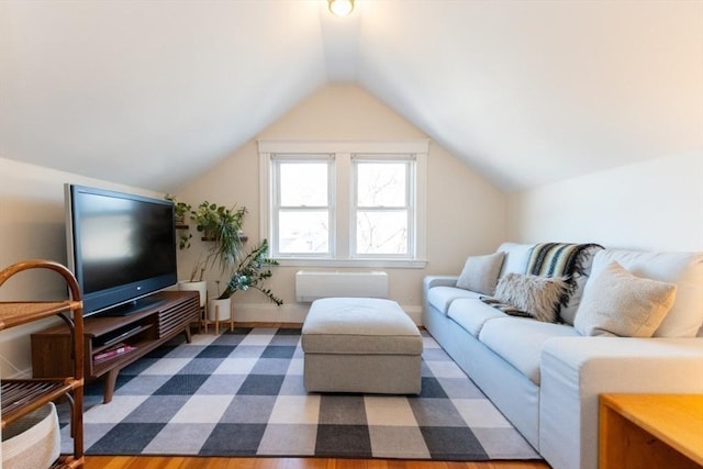 living room with vaulted ceiling and baseboards