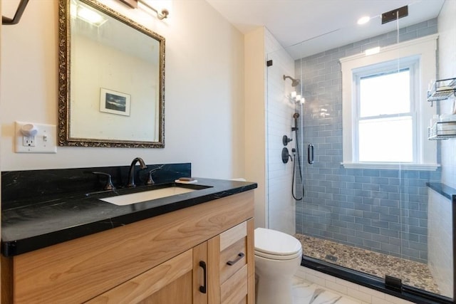 full bath featuring a stall shower, marble finish floor, vanity, and toilet