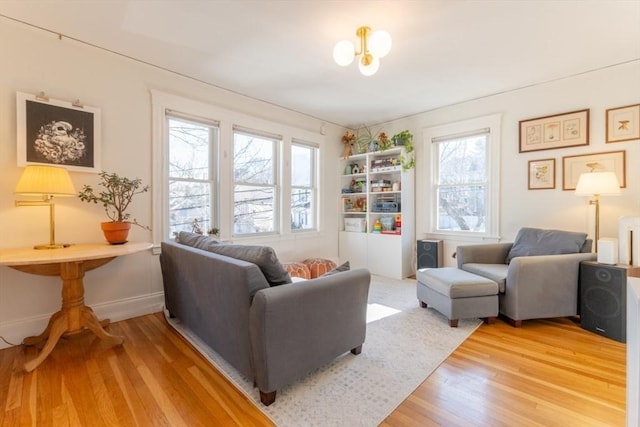 living area featuring light wood-style floors and baseboards