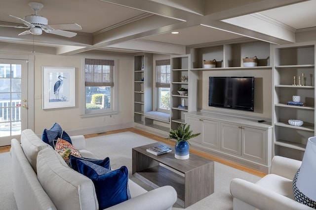 living room with coffered ceiling, light wood-style flooring, ceiling fan, crown molding, and beamed ceiling