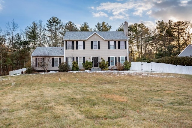 colonial-style house with a front lawn