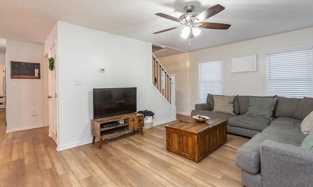 living room with ceiling fan and light wood-type flooring