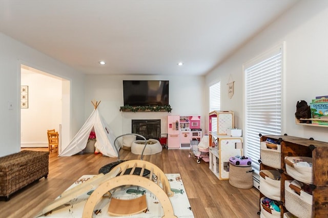 game room with light hardwood / wood-style floors