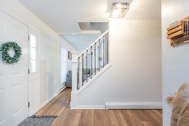 entrance foyer with baseboard heating and light hardwood / wood-style floors