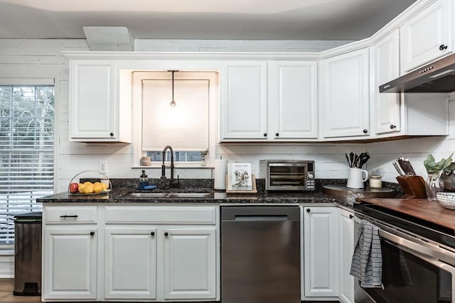 kitchen with white cabinetry, sink, stainless steel appliances, and hanging light fixtures