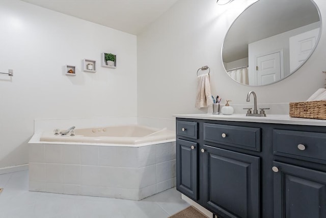 bathroom with vanity, tile patterned flooring, and tiled bath