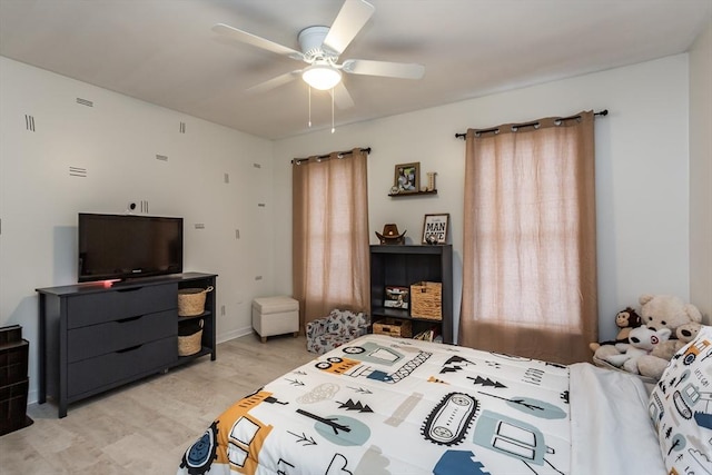 bedroom with ceiling fan and light wood-type flooring