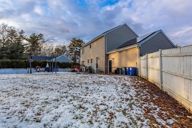 view of snow covered rear of property