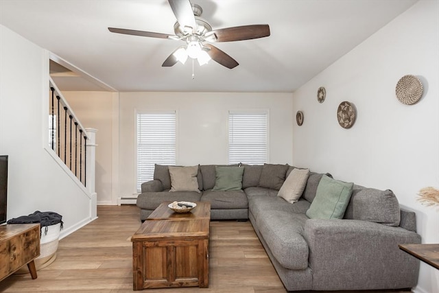 living room featuring ceiling fan and light wood-type flooring