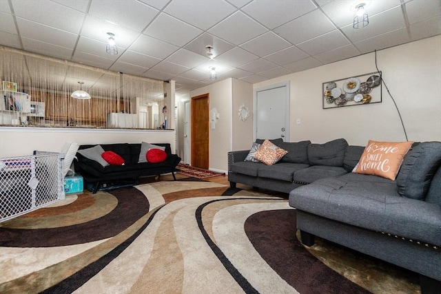 living room with a drop ceiling