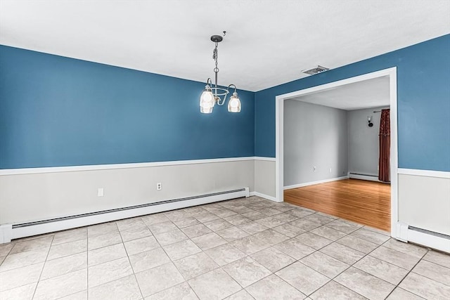 empty room featuring baseboard heating, a baseboard radiator, and light tile patterned floors