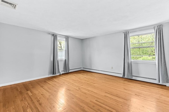 empty room featuring light wood-style floors and baseboards