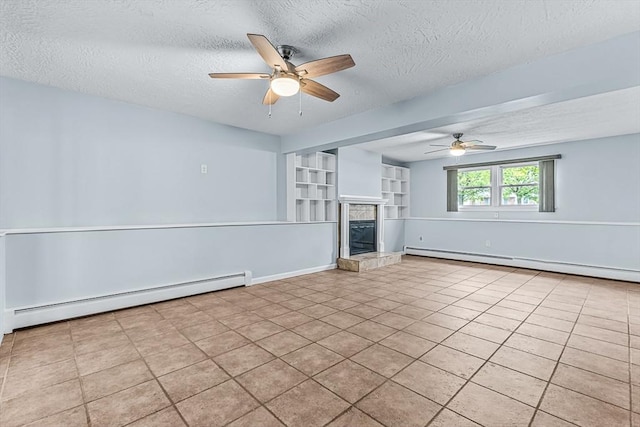 unfurnished living room with a baseboard radiator, a ceiling fan, a textured ceiling, and a tiled fireplace