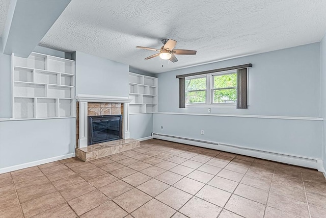 unfurnished living room featuring a baseboard radiator, a ceiling fan, a tile fireplace, a textured ceiling, and tile patterned flooring