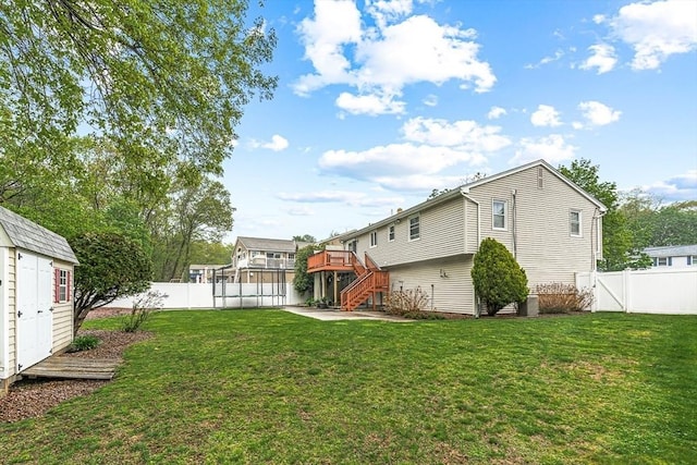 back of house featuring stairway, a deck, an outbuilding, and a storage unit