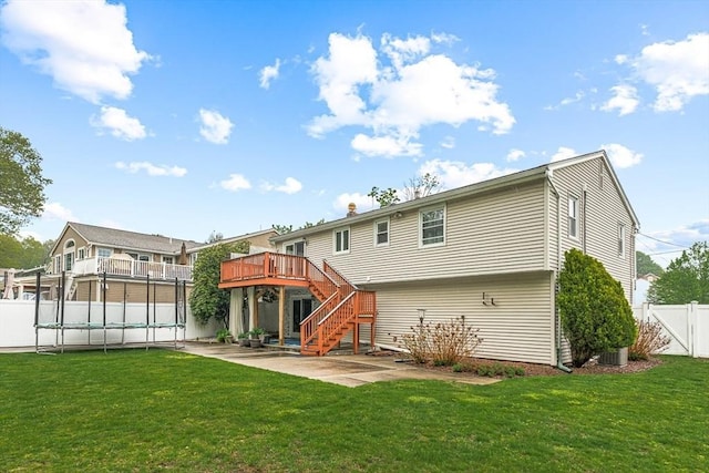 rear view of house with stairway, a patio area, and a wooden deck