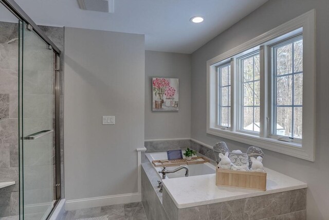 bathroom featuring independent shower and bath