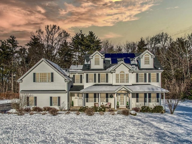 view of front of home with solar panels and a porch