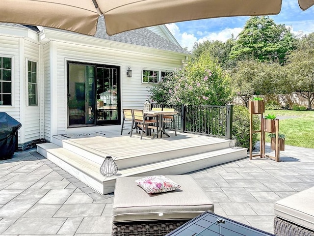 wooden terrace featuring a patio area