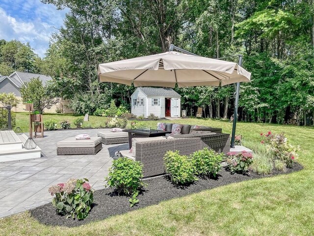 view of patio featuring a storage unit and outdoor lounge area