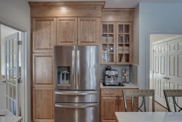 kitchen featuring stainless steel refrigerator with ice dispenser