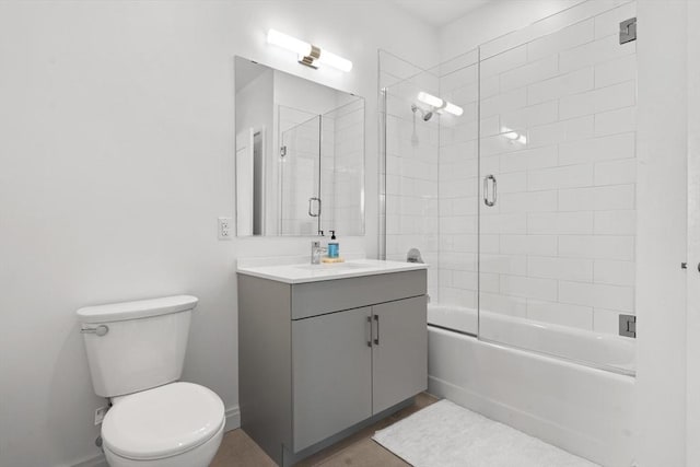 full bathroom featuring toilet, enclosed tub / shower combo, and vanity