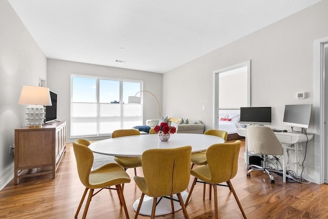 dining area with wood-type flooring