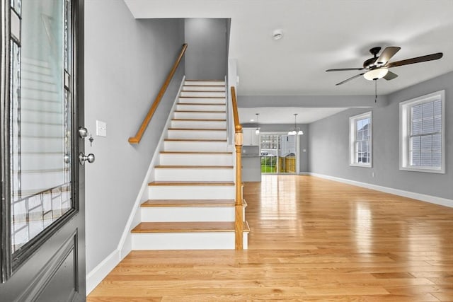 218 Tuttle St, Fall River, MA 02724 - stairway featuring wood finished floors, a ceiling fan, and a chandelier