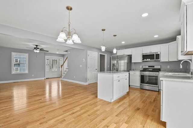 218 Tuttle St, Fall River, MA 02724 - kitchen featuring stainless steel appliances, a center island, light countertops, white cabinets, and recessed lighting