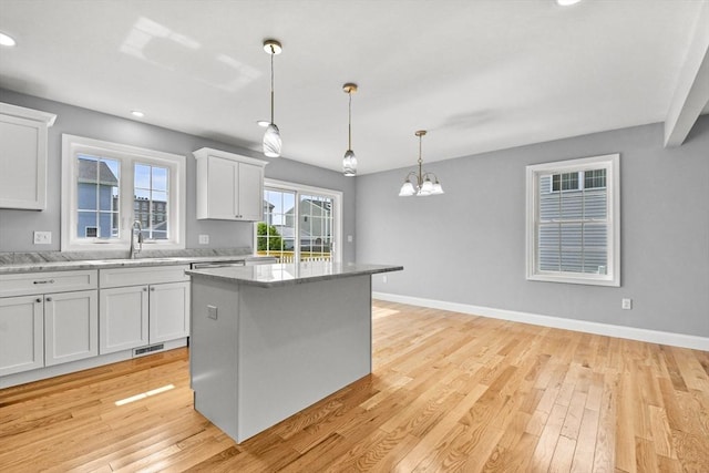 218 Tuttle St, Fall River, MA 02724 - kitchen featuring white cabinetry, a chandelier, light wood-style flooring, recessed lighting, and decorative light fixtures