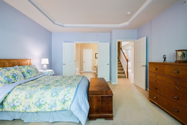 bedroom featuring a raised ceiling, light colored carpet, and ornamental molding