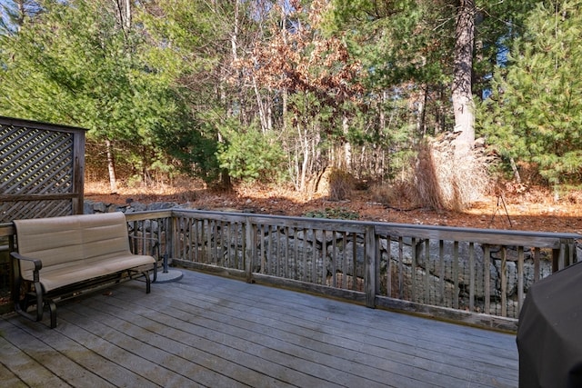 wooden deck with a grill