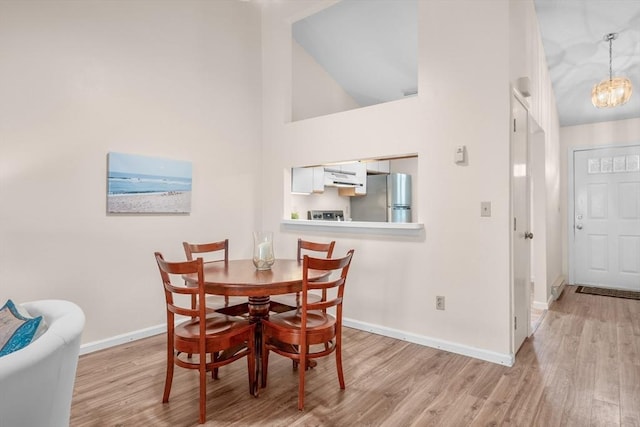 53 Chilton Ln Unit 53, Brewster, MA 02631 - dining room featuring high vaulted ceiling, baseboards, and wood finished floors