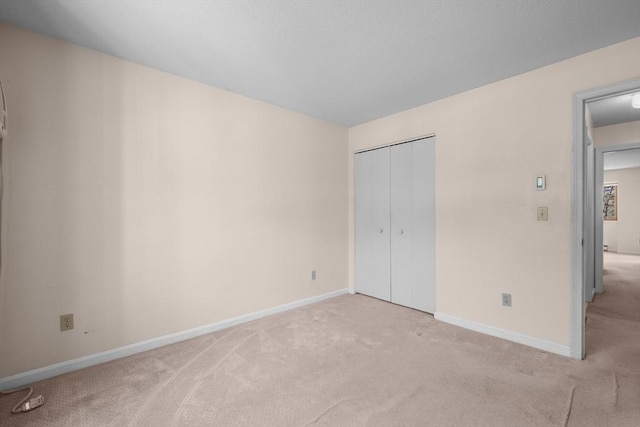 53 Chilton Ln Unit 53, Brewster, MA 02631 - unfurnished bedroom featuring a closet, baseboards, and light carpet