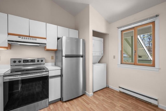 53 Chilton Ln Unit 53, Brewster, MA 02631 - kitchen featuring baseboard heating, stacked washer / dryer, under cabinet range hood, stainless steel appliances, and light wood finished floors