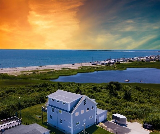 aerial view at dusk with a water view