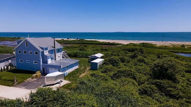 birds eye view of property featuring a water view and a view of the beach