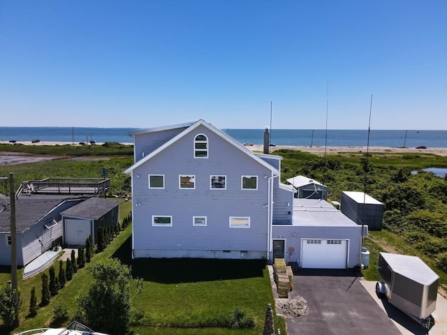 exterior space featuring a water view and a garage