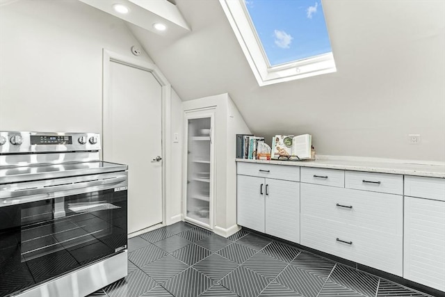 bathroom featuring lofted ceiling, a skylight, and recessed lighting