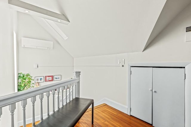 bonus room featuring a wall mounted AC, lofted ceiling, wood finished floors, recessed lighting, and baseboards