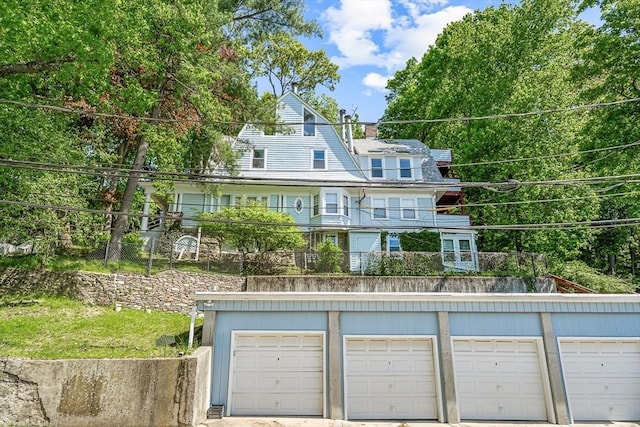 back of house featuring a chimney and fence
