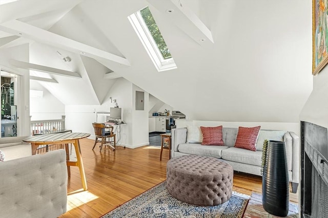living room featuring a skylight, electric panel, lofted ceiling, and wood finished floors
