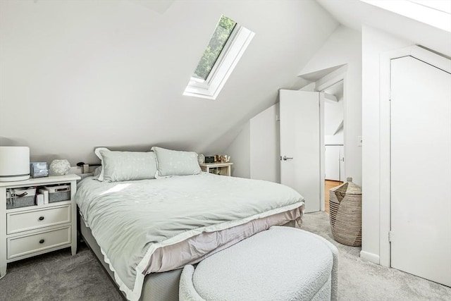 carpeted bedroom featuring a skylight and vaulted ceiling