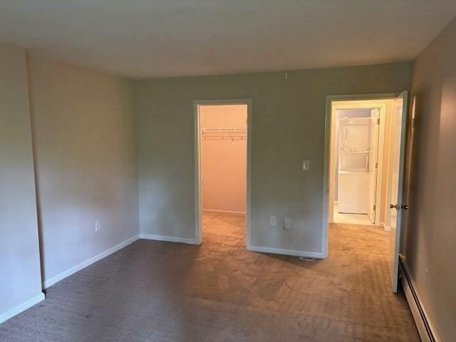 120 Fisherville Rd Unit 121, Concord, NH 03303 - unfurnished bedroom featuring a baseboard radiator, carpet floors, a walk in closet, and baseboards