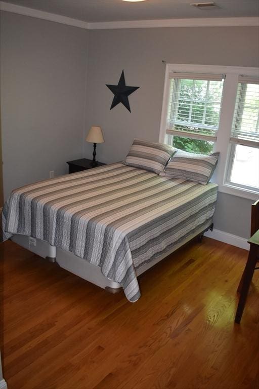 23 Beech St Unit 2, Framingham, MA 01702 - bedroom with ornamental molding and wood finished floors