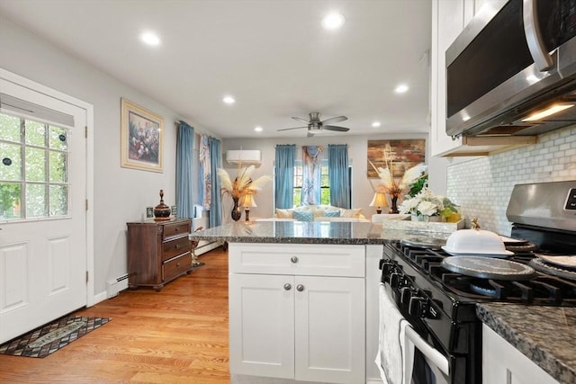 99 Lincoln St, Stoughton, MA 02072 - kitchen featuring range with gas stovetop, stainless steel microwave, a peninsula, healthy amount of natural light, and recessed lighting