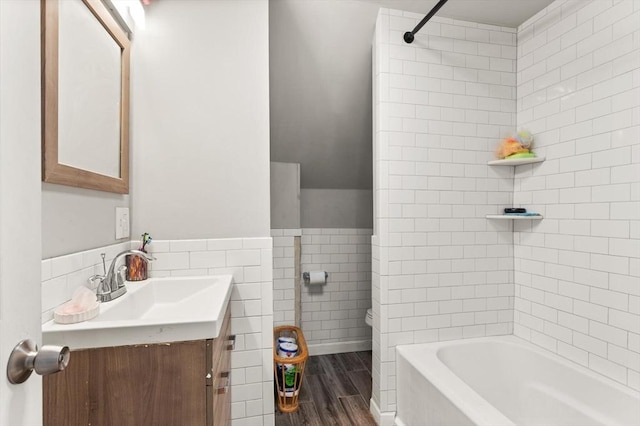 99 Lincoln St, Stoughton, MA 02072 - bathroom with tile walls, toilet, vanity, wood finished floors, and shower / bath combination